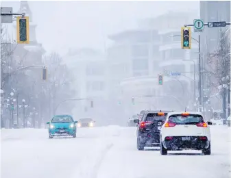  ?? DARREN STONE, TIMES COLONIST ?? Vehicles navigate the snowy road on on Douglas Street in Victoria on Saturday. Most drivers chose to stay at home, and rightly so, writes Steve Wallace.