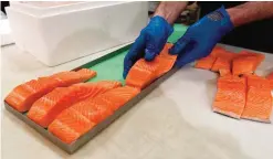  ??  ?? VIRGINIA: In this photo, Canadian certified organic farm-raised King Salmon filets are placed on a tray in a store in Fairfax, Virginia.