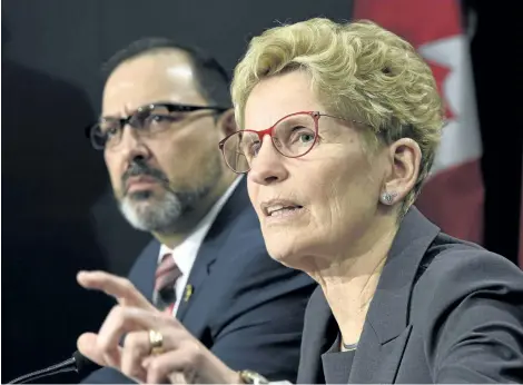  ?? FRANK GUNN/THE CANADIAN PRESS ?? Ontario Premier Kathleen Wynne, right, speaks as Ontario Energy Minister Glenn Thibeault looks on during a press conference in Toronto on Thursday. The Liberal government unveiled its plan today to cut hydro bills, which are the biggest political issue...