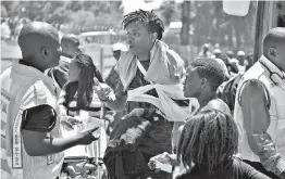  ?? Associated Press ?? An injured passenger receives attention at the scene of a train accident Thursday near Kroonstad, South Africa. South Africa’s transport minister says at least 18 people died and more than 260 were injured in a collision between a truck and a passenger...