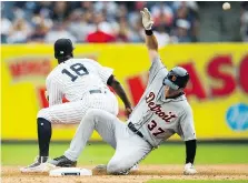  ?? MICHAEL NOBLE JR./THE ASSOCIATED PRESS ?? The Tigers’ Jim Adduci slides into second as the Yankees’ Didi Gregorius awaits the throw Wednesday.