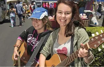  ?? Photo: Kevin Farmer ?? MUSIC TO LIFE: Busking at Margaret Street Markets are Sarah Lamshed (left) and Rhianna McKechnie.