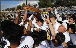  ?? LIPO CHING — STAFF PHOTOGRAPH­ER ?? Lincoln celebrates with the Big Bone trophy after defeating San Jose 51-6 on Thursday.