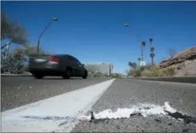  ?? CHRIS CARLSON — THE ASSOCIATED PRESS ?? Cars go by the scene Monday near where a pedestrian was stuck by an Uber vehicle in autonomous mode late Sunday night in Tempe, Ariz.