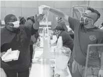  ?? REUTERS ?? Volunteers hand out meals at a Salvation Army facility after winter weather caused electricit­y blackouts in Plano, Texas. Nearly half of Texans remain without access to water even as the power grid returns.