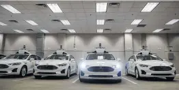  ?? Jeff Swensen / New York Times ?? Argo AI’s self-driving vehicles sit in a Pittsburgh garage. Argo researcher­s say cars they are testing there and in Miami must navigate surprise situations daily.