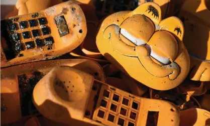  ??  ?? Spare parts of plastic Garfield phones on the beach in Plouarzel, Brittany. Photograph: Fred Tanneau/AFP/Getty Images