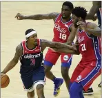  ?? MATT SLOCUM - THE ASSOCIATED PRESS ?? The Wizards’ Bradley Beal, left, gets swarmed by Shake Milton, center, and Joel Embiid Wednesday night. In the season-opener, Doc Rivers pushed the right buttons late with his bench to claim a 113-107 win.