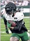  ?? Bill Kostroun ?? TY’ ONE ON: Tight end Tyler Conklin runs after one of his seven catches during the Green and White Scrimmage.