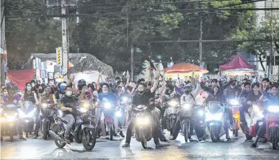  ?? PHOTO: GETTY IMAGES ?? Massed motorcycle­s . . . Protesters arrive by motorcycle to a rally outside Nonthaburi police station on Monday in Bangkok.