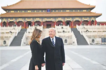  ?? Jim Watson, AFP/Getty Images ?? President Donald Trump and first lady Melania Trump tour the Forbidden City — the imperial palace that served as the political center of China’s government for almost 500 years — after arriving in Beijing on Wednesday.