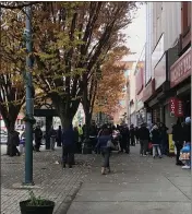  ?? ?? A crowd forms as parademics remove a man who was shot in the chest about 1:30p.m. Monday Nov. 22, in the 500 block of Penn Street in Reading. The man died a short time later in Reading Hospital.