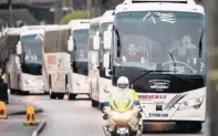  ??  ?? CONCERN Convoy of coaches transports Britons evacuated from Wuhan.
Far left, Prof Jeffery