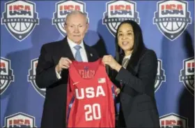  ?? SEAN RAYFORD — THE ASSOCIATED PRESS ?? National Basketball Chairman Gen. Martin Dempsey, left, presents a jersey to South Carolina women’s head basketball coach Dawn Staley, right, during a press conference on Friday.