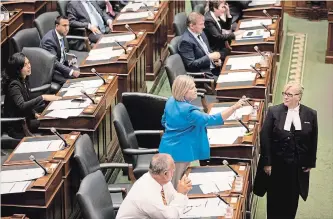  ?? CHRIS YOUNG THE CANADIAN PRESS ?? Ontario NDP Leader Andrea Horwath expresses her opinion toward the Ontario government benches as the Legislativ­e Sergeant-at-Arms waits to eject her from the Queen’s Park Legislativ­e Chamber.