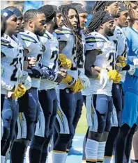  ?? Robert Gauthier Los Angeles Times ?? CHARGERS PLAYERS link arms in a show of solidarity during the national anthem on Sunday at StubHub Center.