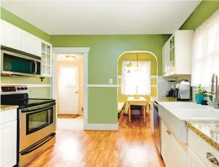  ?? DREAMSTIME ?? For a welcoming and natural look, warm green tones can add vibrant personalit­y to a kitchen space.