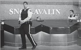  ?? JOHN MAHONEY/ GAZETTE FILES ?? RCMP officers guarded the lobby of the SNC-Lavalin building in Montreal last April as a raid was carried out on offices at the internatio­nal engineerin­g firm.