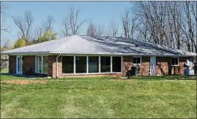  ??  ?? The front door opens directly into an open floor plan with a combinatio­n of a living room and dining room area. French patio doors open from the living room to a side concrete patio.