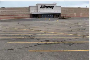  ?? (AP) ?? An empty parking lot is shown in May outside a closed J.C. Penney store in Roseville, Mich.