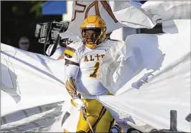  ?? MARC PENDLETON / STAFF ?? Alter senior defensive lineman Nathaniel Armstrong leads the Knights on to the field before Thursday’s season opener against Fairmont.