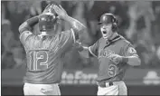  ?? Jae C. Hong Associated Press ?? MARTIN MALDONADO and Ian Kinsler celebrate after scoring on a fifth-inning single by Mike Trout.