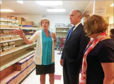  ?? EVAN BRANDT — DIGITAL FIRST MEDIA ?? Barbara Wilhelmy, left, executive director of the Cluster Outreach Food Pantry in Pottstown, gives U.S. Sen. Bob Casey a tour of the facility before he departed for Washington, D.C., to vote on the Senate’s farm bill.