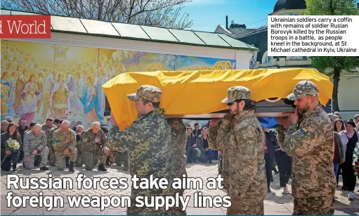  ?? ?? Ukrainian soldiers carry a coffin with remains of soldier Ruslan Borovyk killed by the Russian troops in a battle, as people kneel in the background, at St Michael cathedral in Kyiv, Ukraine