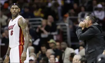  ??  ?? In this 2010 file photo, a Cleveland Cavaliers fan yells at Miami Heat forward LeBron James (6) during the first quarter of an NBA basketball game in Cleveland. AP Photo/toNy DejAk