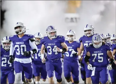  ?? (NWA Democrat-Gazette/Caleb Grieger) ?? The Booneville Bearcats enter the field before their Class 3A state semifinal game against Glen Rose on Dec. 1 in Booneville. The Bearcats are playing in their 10th state championsh­ip game today and are looking for their fifth title.