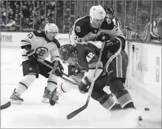  ?? FRANK FRANKLIN II/AP PHOTO ?? Scott Mayfield of the Islanders (42) checks Zdeno Chara of the Bruins (33) during the first period of Thursday’s game at New York. The Bruins won 5-2.