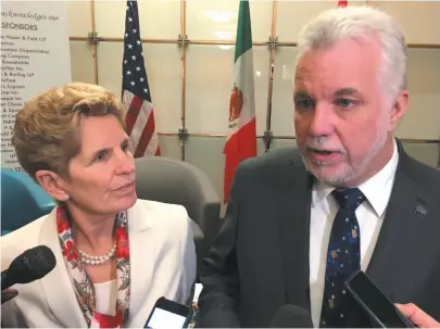  ?? CP PHOTO ?? Ontario premier Kathleen Wynne and Quebec premier Philippe Couillard speak to reporters after an event at the Washington internatio­nal trade associatio­n in Washington, D.C., on Friday.
