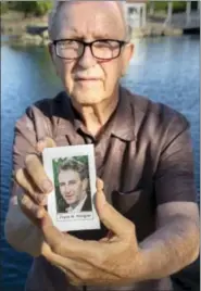  ??  ?? In this Friday, June 23, 2017 photo, Frank Kerrigan holds onto a a funeral card for his son Frank, near Wildomar, Calif. Kerrigan, who thought his son had died, learned he buried the wrong man. Kerrigan said the Orange County coroner’s office...