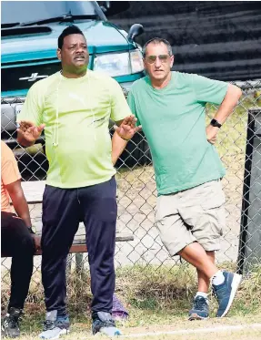  ?? RICARDO MAKYN/MULTIMEDIA PHOTO EDITOR ?? Coach Donovan Duckie (left) and team owner Peter Gould look on during Mount Pleasant’s Magnum/Charley’s JB/JFF Premier League play-off match against Barbican at the Barbican playfield on Sunday July 1,2018.