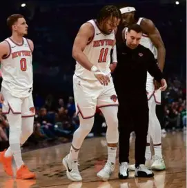  ?? SUE OGROCKI/ASSOCIATED PRESS ?? The Knicks got a scare when Jalen Brunson suffered a left knee bruise in the first minute of a win over the Cavaliers.