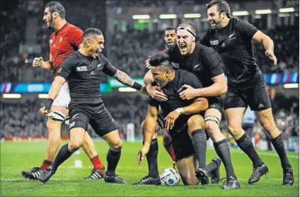  ??  ?? A frightenin­g sight: The All Blacks celebrate another try in their victory over France.