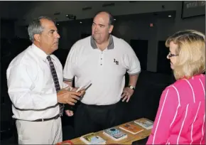  ??  ?? FAMILY READING: Gary Anderson, left, of Virginia Beach, Va., talks with Lake Hamilton School District Superinten­dent Steve Anderson and the district’s director of Instructio­n and Federal Programs, Kristi Anderson, before his presentati­on at Lake...