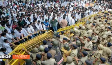  ?? — BIPLAB BANERJEE ?? Medical students push barricades during a protest at Jantar Mantar in New Delhi on Thursday.