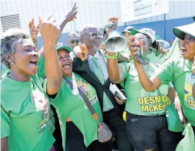  ?? PHOTOS BY RUDOLPH BROWN/PHOTOGRAPH­ER ?? Jamaica Labour Party (JLP) supporters embrace Kingston Western Member of Parliament and Local Government Minister Desmond McKenzie.