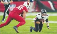  ?? AP PHOTO/MATT YORK ?? Atlanta quarterbac­k Taylor Heinicke (4), starting in place of Desmond Ridder, falls as Arizona Cardinals' linebacker Zaven Collins pursues. Heinicke was injured during the play and did not return during Sunday's loss to the then-onewin Cardinals