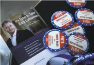  ??  ?? Top: A registered voter (left) fist-bumps with Xiaoshan Song, canvassing with Michele Guerra in Concord with campaign material for Republican gubernator­ial candidate Travis Allen, above.