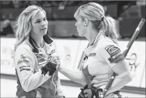  ?? CP PHOTO ?? Canada skip Jennifer Jones celebrates her team’s victory over Russia with teammate lead Dawn McEwen, right, at the World Women’s Curling Championsh­ip, Thursday, in North Bay, Ont.