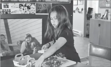  ??  ?? Sophie Gaulin prepares strawberri­es for jam making.