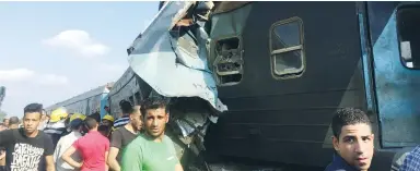  ?? (Osama Nageb/Reuters) ?? EGYPTIANS LOOK at two trains that collided near the Khorshid station in Alexandria on Friday.