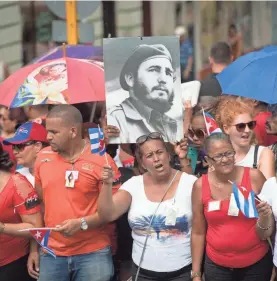  ?? JACK GRUBER/USA TODAY ?? Cubans gather at historic Cespedes Park in Santiago on Dec. 3, 2016, the week after Cuba’s longtime charismati­c leader Fidel Castro died.