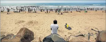  ??  ?? COOL WATERS: East Londoners enjoy themselves at Eastern Beach yesterday