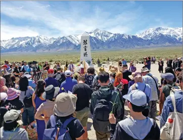  ?? Photo courtesy of National Park Service/Manzanar ?? People from diverse background­s participat­e in the Manzanar Pilgrimage interfaith ceremony during the Manzanar Pilgrimage. This year’s pilgrimage marks the event’s 55th year, which started in December 1969 when a group of about 150 people journeyed to Manzanar, though others had been making the trek unofficial­ly for years before that. The pilgrimage and Manzanar National Historic Site emphasizes the protection of human and civil rights for all by preserving the stories from the site’s dark past.