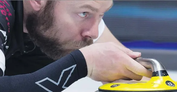  ?? ANDREW VAUGHAN/THE CANADIAN PRESS ?? B.J. Neufeld, third on the wild card team, delivers a rock during their win over Northwest Territorie­s at the Tim Hortons Brier in Regina on Tuesday.