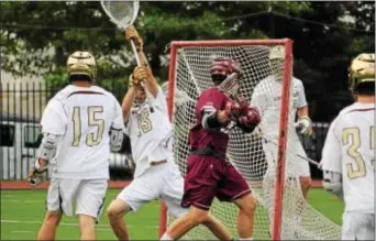  ?? FOR DIGITAL FIRST MEDIA — MATT CHANDIK ?? Culver Academy’s Austin Madronic, center, goes behind the back to beat Haverford School goalie Parker Henderer for his second goal of the first quarter Sunday. Madronic finished with four goals and two assists to lead Culver to a 9-5 win in the...