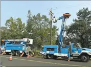  ?? JOSE CARLOS FAJARDO — STAFF ARCHIVES ?? A PG&E crew works on repairs an electrical line on Atlas Peak Road after it was damaged by the Atlas Peak Fire.